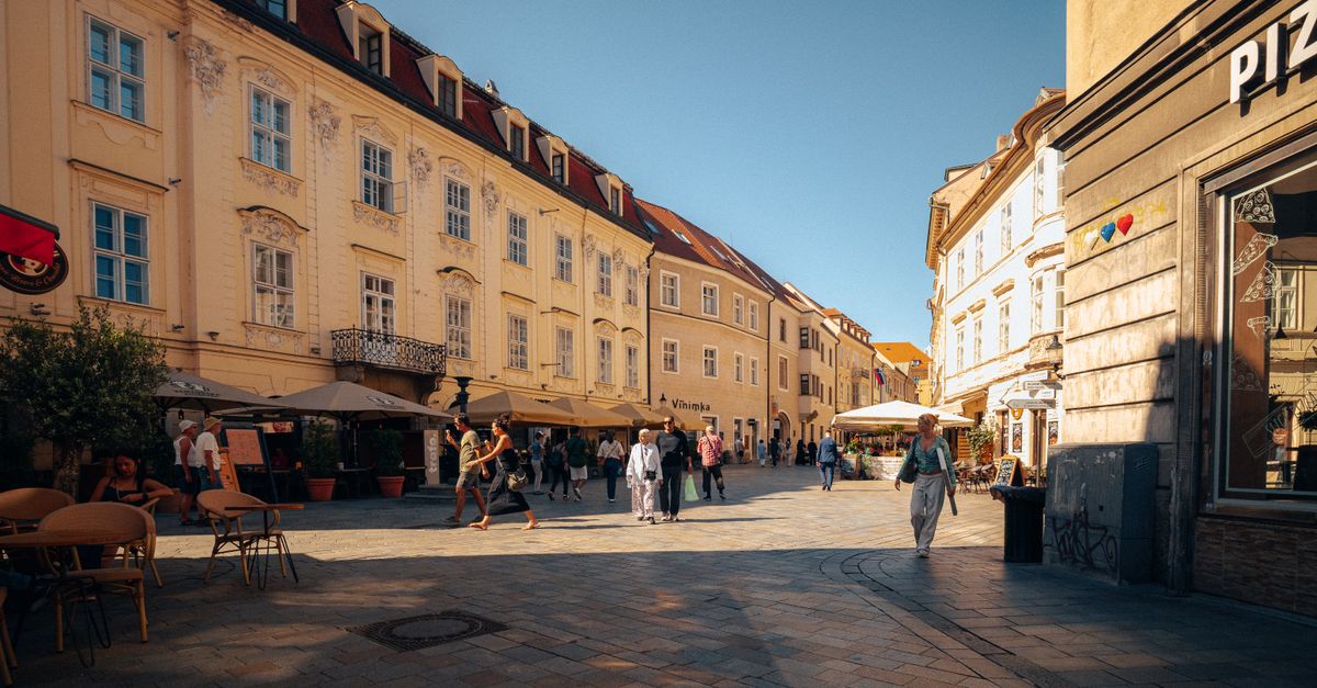 A morning cafe in an old-town street at the start of a culture day.